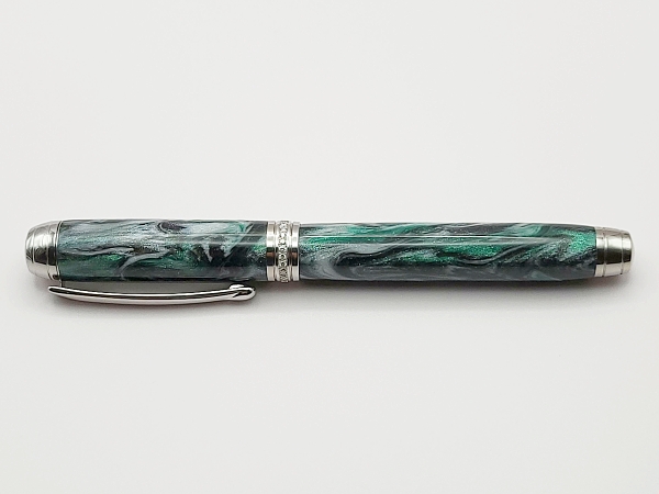 A rhodium plated Mistral fountain pen in DiamondCast Emerald Green, with a bespoke diamond centre band and an 18k solid gold Bock nib